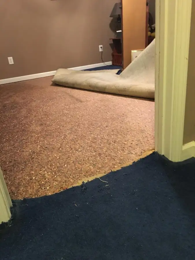 Carpet pad removal revealing water damage during Water Mitigation Services in Cherry Valley